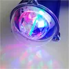 A close-up shot of a rotating LED party light with colorful beams projected onto a surface. Produktbild-Vorschau