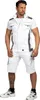 A man is standing and posing in workwear shorts and a vest. Produktbild-Vorschau