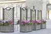 Outdoor cafe setting with planters and trellises. Anteprima dell’immagine prodotto