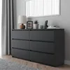 A modern black dresser with six drawers, shown in a room setting with a curtain and a mirror in the background. Náhľad obrázku produktu