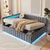 A modern bedroom with a grey upholstered bed frame featuring integrated LED lighting. Náhled obrázku produktu