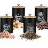 A set of four black storage canisters with bamboo lids, each labeled with a chalk-like drawing and text indicating its contents: Salt, Sugar, Tea, and Coffee. Various ingredients are displayed in front of the canisters. Náhľad obrázku produktu