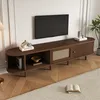 A modern living room with a TV stand and a television mounted on the wall.