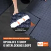 A person is installing interlocking garage floor tiles. Voir les images du produit