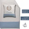 A flat lay of a nautical-themed duvet cover and pillowcase set with an anchor motif and the text 'Küstenkind'. Produktbild-Vorschau