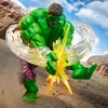 A Hulk action figure in a dynamic pose, with energy effects, set against a rocky, outdoor background. Náhľad obrázku produktu