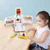 A young girl is playing with a toy ambulance doctor kit on a wooden table. Anteprima dell’immagine prodotto