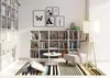 A cozy living room scene with a bookshelf, armchair, and floor lamp. Anteprima dell’immagine prodotto