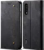 A black flip-style phone case with a denim texture and stitching detail, shown from the front and back. Produktbild-Vorschau