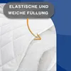 A close-up view of a white quilted blanket, with an orange arrow pointing to the soft filling underneath. Produktbild-Vorschau