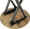 Close-up view of the base of a round stool with a wooden top and black metal legs. Produktbild-Vorschau
