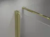 A close-up view of a shower cabin corner with gold-colored metal profiles and transparent glass panels. Produktbild-Vorschau