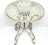 A round metal garden table with a decorative top and ornate legs, presented on a white background. Náhled obrázku produktu