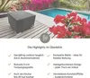 A table and flowers next to a swimming pool. Produktbild-Vorschau