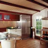A kitchen with wooden beams and walls, featuring a large stainless steel refrigerator, red cabinets, a glass dining table with a white chair, and a window overlooking a green landscape. Produktbild-Vorschau