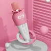 A pink and white cartoon-like microphone with a face and flower-like details, presented in a pink, stylized setting with spheres. Produktbild-Vorschau