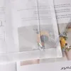 A close-up view of a sheer white curtain with printed text and a sunflower image visible through it. Produktbild-Vorschau
