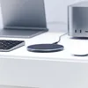 A desk setup with a laptop, keyboard, wireless charger, and computer tower. Produktbild-Vorschau