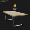 A table with a light brown wooden top and black angular legs. Produktbild-Vorschau