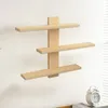 A light wood, three-tiered wall shelf mounted on a white wall. Produktbild-Vorschau