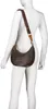 A mannequin wearing a white long-sleeved shirt and a brown Valentino Bags Regina Beuteltasche. Produktbild-Vorschau
