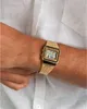 A close-up shot of a person's wrist wearing a gold digital watch. Produktbild-Vorschau