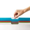 A hand is shown selecting a cutting board from a set. Podgląd zdjęcia produktu