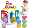 A baby playing with a multi-functional activity cube and stacking toys. Produktbild-Vorschau