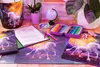 A desk setup with school supplies, including a unicorn-themed desk mat, pencil case, and notebook. Náhľad obrázku produktu