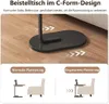 Schwarzer C-förmiger Beistelltisch mit ovalem Sockel, neben einem Sofa gezeigt und normale sowie versenkte Platzierung demonstrierend Voir les images du produit