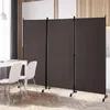 A three-panel room divider with wheels is set up in a dining area, partially obscuring a kitchen in the background. Two white chairs and a table are visible in the foreground. Produktbild-Vorschau