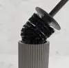 A black toilet brush is placed in a gray holder against a marble-patterned background. Anteprima dell’immagine prodotto