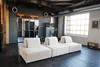 A modern loft-style living room with a modular sofa, large windows, and industrial elements. Produktbild-Vorschau