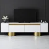 A modern white TV stand with gold accents is shown in a room with a black wall and a white floor. Náhľad obrázku produktu