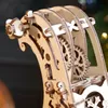 A close-up view of a wooden 3D puzzle, showing intricate gears and carved details. Produktbild-Vorschau