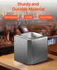 A metallic cube-shaped product sits on a wooden surface in front of a blurred bar background. Anteprima dell’immagine prodotto