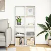 A white bookshelf filled with books, a plant, and decorative items, placed next to a sofa and a large plant in a room. Podgląd zdjęcia produktu