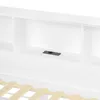 A close-up view of a white bed frame with a built-in shelf and a black electrical outlet. Produktbild-Vorschau