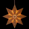 A star-shaped lantern with multiple layers, illuminated from within, against a black background. Produktbild-Vorschau