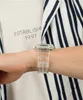 A close-up shot of a person's wrist wearing a transparent watch. Produktbild-Vorschau