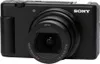 A black Sony digital camera is shown from the front. Produktbild-Vorschau