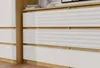 A close-up view of a modern dresser with white drawers and wooden accents. Podgląd zdjęcia produktu