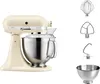 A cream-colored KitchenAid Artisan stand mixer with various attachments displayed next to it, all on a white background. Produktbild-Vorschau