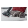 A sleeping cat on a sofa next to a vacuum cleaner attachment. Produktbild-Vorschau