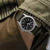 A close-up shot of a Hamilton Khaki Field Mechanical watch on a person's wrist, with the watch strap and part of the person's clothing visible. Podgląd zdjęcia produktu