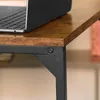 A close-up view of the corner of a wooden table with a black metal frame, showing a laptop on top. Produktbild-Vorschau