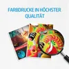 Marketing image showing two printed documents, one with a logistics chart and the other with a colorful dragon design, viewed through a magnifying glass. Produktbild-Vorschau