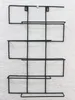 A black metal wine rack mounted on a textured white wall. Náhľad obrázku produktu