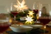 A table setting with wine glasses and decorative stars. Produktbild-Vorschau
