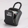A close-up of a black combination lock key safe with its door open, revealing a key and cards inside. Anteprima dell’immagine prodotto